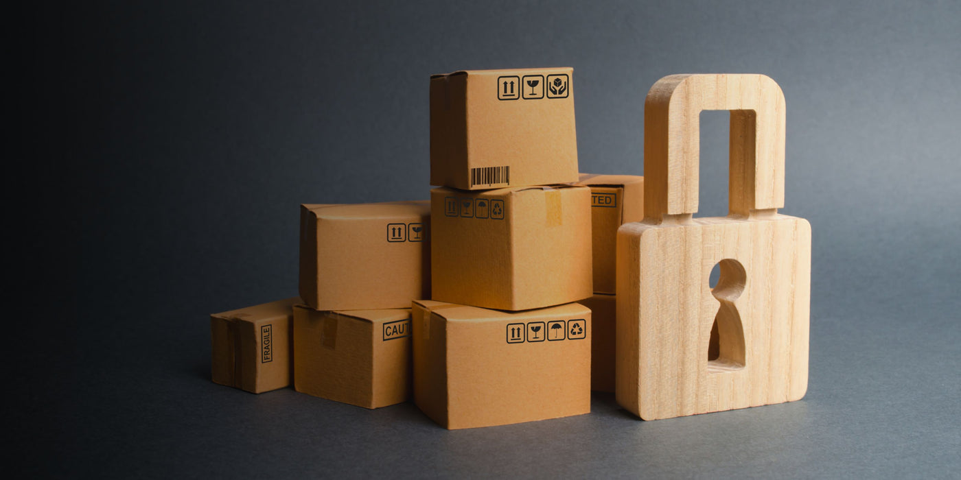 Stack of cardboard boxes with a wooden lock on a dark background