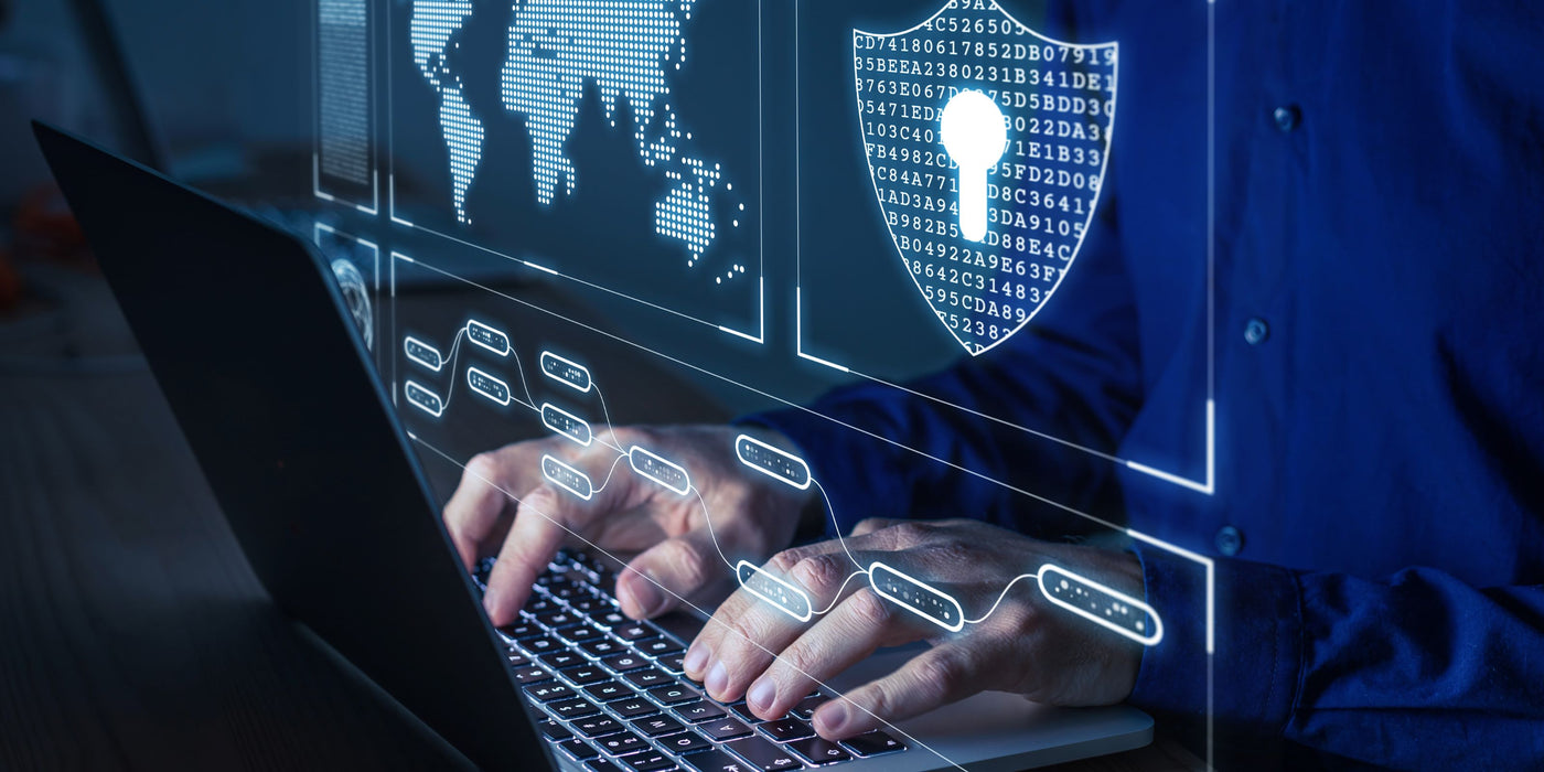 Person using a laptop with digital security icons on a screen
